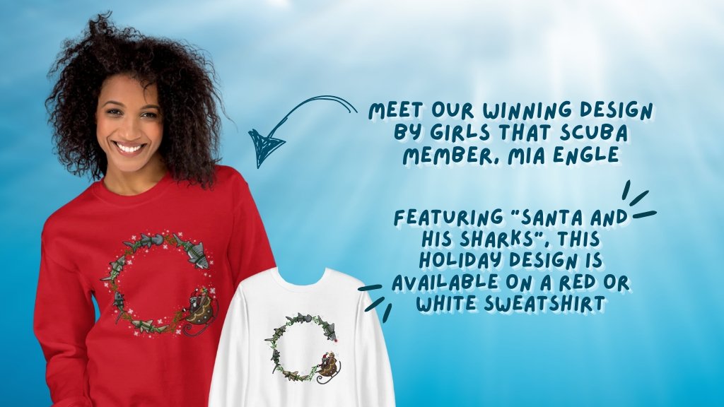 A woman is wearing a red sweatshirt with a christmas-themed scuba diver motif on the front. Overlaid text reads "Meet our winning design by Girls that Scuba member, Mia Engle. Featuring "Santa and his sharks", this holiday design is available on a red or white sweatshirt.